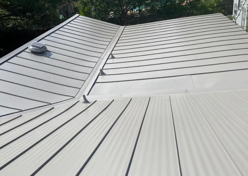 Solar attic fan installed on a metal roof for Roof Ventilation in Chestnut Ridge